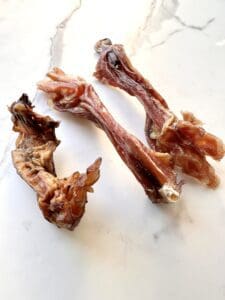 Three pieces of beef tendons on a marble table.